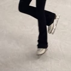 a man riding a skateboard on top of a white floor next to another person