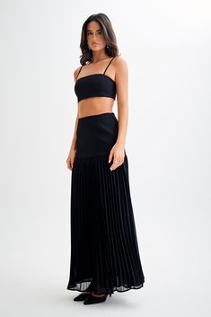 Going with the flow.The JILLIAN Pleated Maxi Skirt is a sophisticated and elegant addition to any wardrobe. This high-waisted skirt features a fitted yoke that transitions into a beautifully pleated chiffon lower skirt, offering a graceful flow and movement. With its maxi length, it exudes timeless charm. Pair it with the Letitia Suiting Halter Top with Buckle for a chic and polished ensemble. Black Sheer Skirt, Capsule Wardrobe Accessories, Going With The Flow, European Summer Outfits, Maxi Dress Sale, Sheer Skirt, Pleated Chiffon, Capsule Outfits, Pleated Maxi Skirt