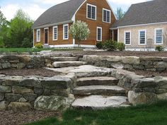 a stone patio in front of a house