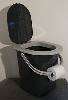 a toilet that is sitting on top of a black box with its lid open and the seat up