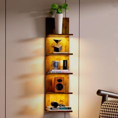 a wooden shelf with books and other items on it next to a chair in a room