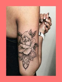 a woman's arm with a rose tattoo on the left side of her arm