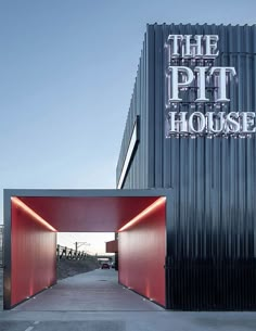 the pit house entrance is lit up with red lights and an open door leading into it