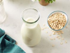 a bowl of oatmeal next to a glass of milk