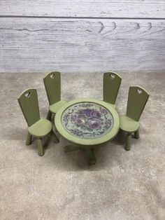 a green table with six chairs around it