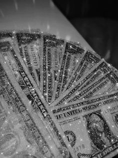 one hundred dollar bill is shown in black and white with snow falling on the ground