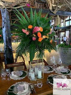 a table set with flowers and place settings