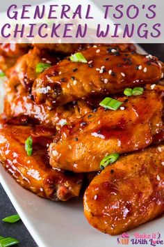 the chicken wings are covered in sauce and garnished with scallions on top