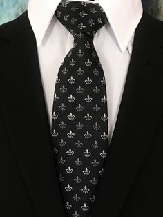 "Perfect for a black tie wedding. This black tie with Fleur De Lis design is a classic must have tie. Available as a extra long neck tie. Handmade from 100% silk, this special collection features a .75\" Eds Neckties logo at the bottom right front corner of every tie and a larger logo located on the tipping (Back of the tie). The label features the collection name (Nathaniel Alexandria) Named after my son Nathaniel and my daughter Alexandria. Expertly hand-made from 100% silk you can select your Luxury Black Tie For Formal Occasions, Classic Black Suit And Tie Accessories, Classic Fitted Black Suit And Tie Accessories, Luxury Black Suit And Tie Accessories For Business, Elegant Black Standard Tie And Suit Accessories, Black Tuxedo Suit And Tie Accessories For Formal Occasions, Classic Black Suit And Tie Accessories For Formal Occasions, Elegant Black Suit And Tie Accessories, Black Tie For Black Tie Events