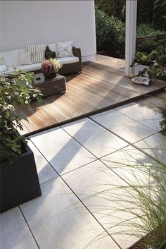 an outdoor living area with patio furniture and plants