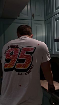 a man standing in front of an oven with the number 95 on it