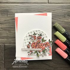 some crayons and markers are sitting on a table next to an artisan card