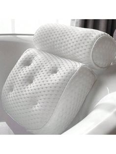 a close up of a pillow in a bathtub