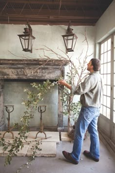 a man standing in front of a fire place