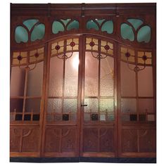 an ornate wooden door with stained glass panels