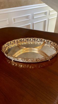 a metal tray sitting on top of a wooden table next to a white cabinet door