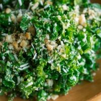 a wooden bowl filled with chopped green vegetables