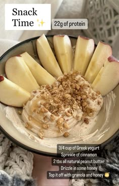 a bowl filled with oatmeal and sliced apples on top of a table