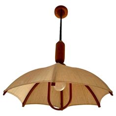 a light hanging from a ceiling fixture with a wooden frame and fabric covering on it