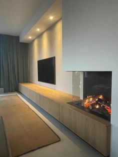 a living room with a fire place next to a flat screen tv mounted on the wall