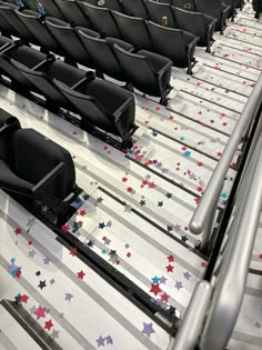 rows of seats with stars on them in an airport