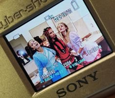 an old sony digital camera with three girls on it's screen and the words sony below