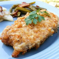 a blue plate topped with chicken and vegetables