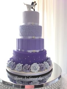 a three tiered purple and white wedding cake