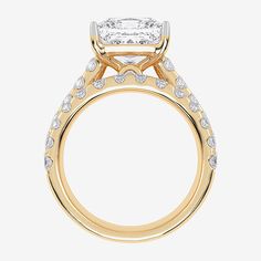 a yellow gold engagement ring set with a princess cut center stone surrounded by small diamonds