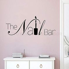 the nail bar wall decal is shown in black on a pink wall behind a white dresser