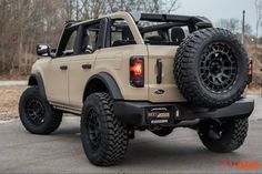 an off - road vehicle is parked in a parking lot with its rear tire up