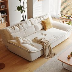 a living room filled with furniture and lots of windows