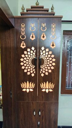 a large wooden cabinet with many different designs on it's doors and handles, sitting in a room