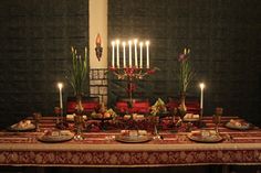 a table with candles and plates on it