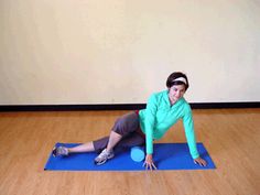 a woman is doing yoga on a blue mat