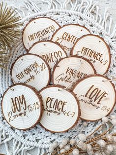 wood slices with names and date printed on them sitting on a doily next to pine cones