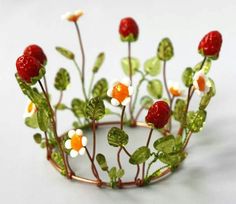 a close up of a wire crown with flowers and leaves