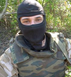 a man in camouflage is wearing a black mask