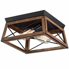 a square light fixture with wood and metal accents