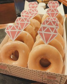 a box filled with lots of donuts covered in frosting