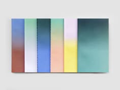 an abstract painting with different shades of blue, green, yellow and pink on the wall