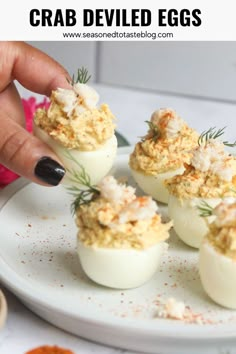 Image of six crab deviled eggs served on a white matte plate. Hand is picking up one crab deviled egg. Crab Stuffed Deviled Eggs, Lobster Deviled Eggs, Seafood Deviled Eggs, Crab Deviled Eggs, Stuffed Deviled Eggs, Deviled Crab Recipe, Crab Deviled Eggs Recipe, Angel Eggs, Deviled Eggs Recipes