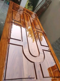 a close up of a wooden door with decorative designs on it