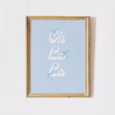 a blue and white print with the words oh la la la la on it in gold frame