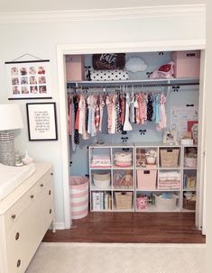 a baby's closet with lots of clothes and other items on shelves in it