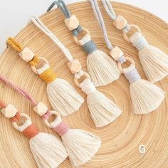 six tasseled necklaces on a woven tray with wooden beads and wood charms