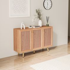 a wooden cabinet sitting on top of a hard wood floor next to a white wall