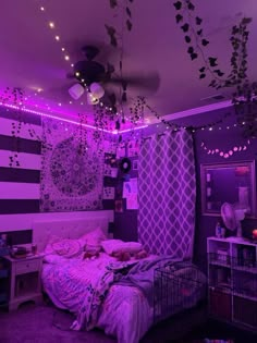 a bedroom with purple lights and a bed