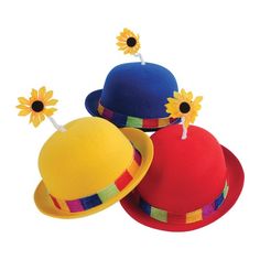 three hats with sunflowers on them sitting next to each other