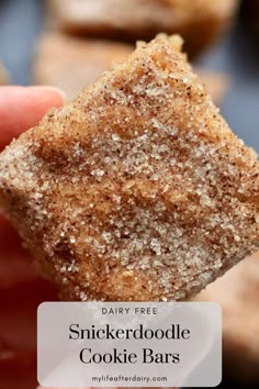 a close up of a person holding a cookie bar